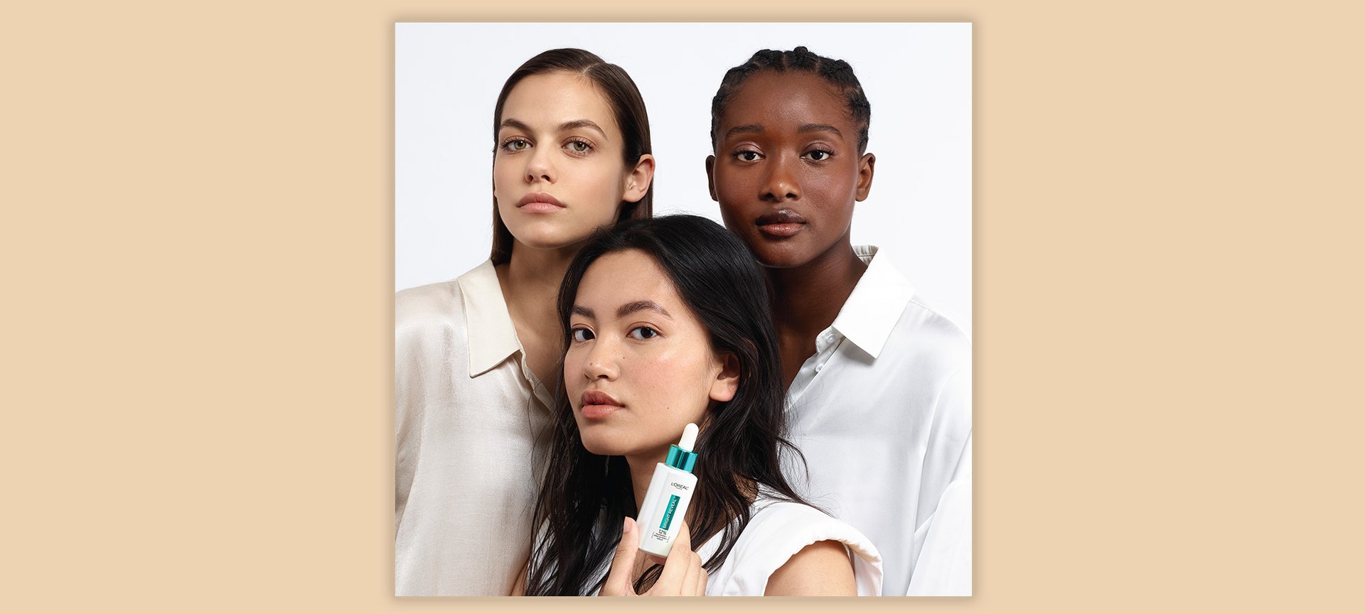 A Group Of People With One Person Holding The Loreal Paris Bright Reveal Niacinamide Serum For Dark