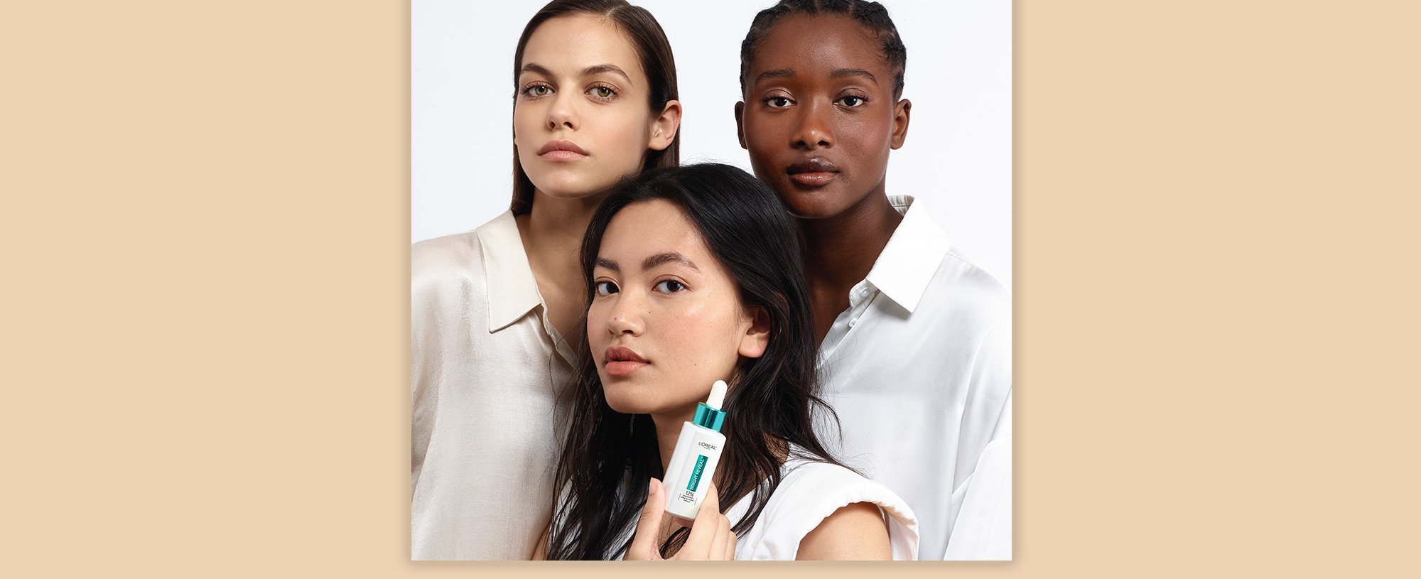 A Group Of People With One Person Holding The Loreal Paris Bright Reveal Niacinamide Serum For Dark